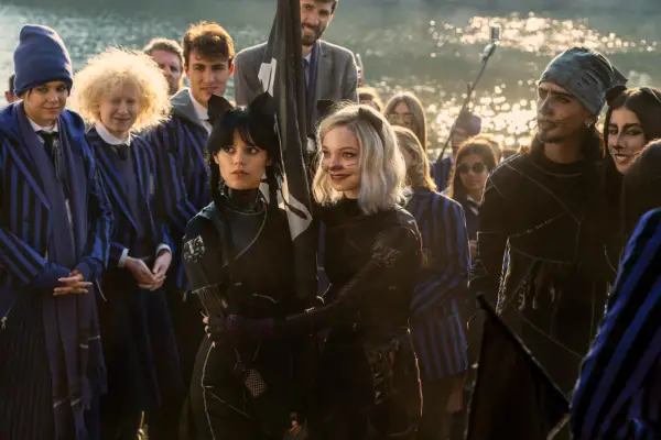 Jenna Ortega as Wednesday Addams, Emma Myers as Enid Sinclair in Wednesday gathered in a crowd