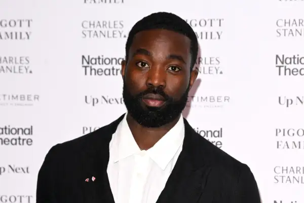 Paapa Essiedu in a black suit at a theatre event