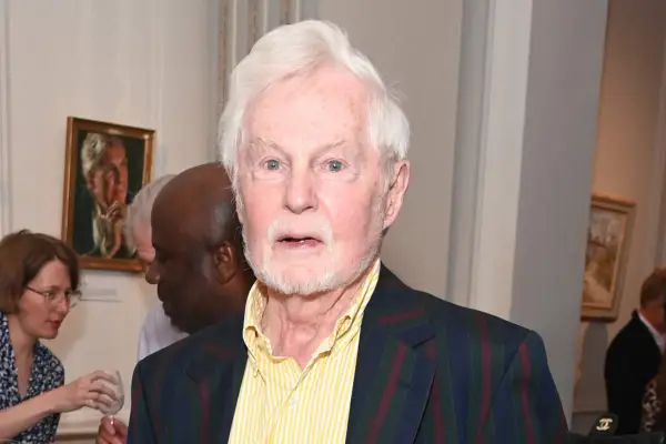 Derek Jacobi wearing a chequered suit