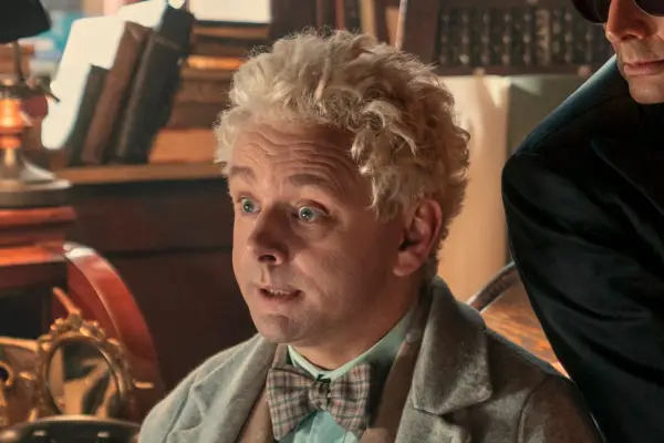 Michael Sheen in Good Omens season 2, wearing a brown suit and beige jacket