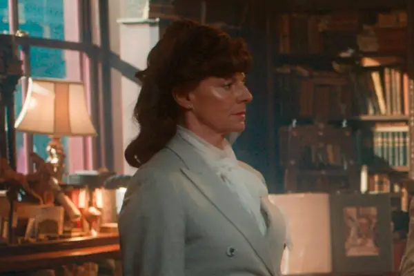 Doon Mackichan in Good Omens season 2, wearing a blue-grey suit
