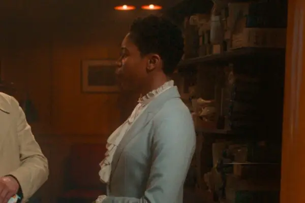 Gloria Obianyo in Good Omens season 2, wearing a blue-grey suit