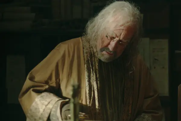 Simon Callow in The Witcher, in a yellow robe