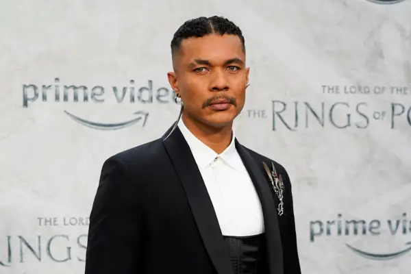 Ismael Cruz Cordova poses on the red carpet of The Lord of the Rings: The Rings of Power