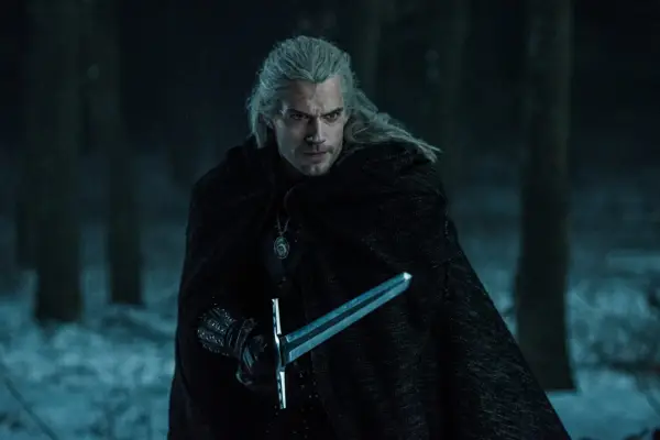 Henry Cavill as the Witcher, holding a sword