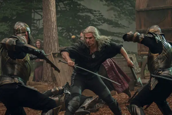 Henry Cavill as Geralt in The Witcher fighting soldiers with a sword