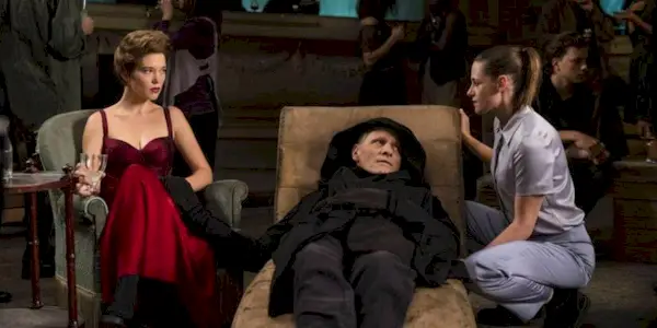 Timlin kneeling to talk to Caprice and Saul in Crimes of the Future.