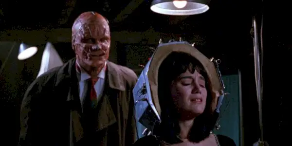 The killer creeping up on a victim in Popcorn