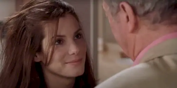 FBI agent Gracie Hart (Sandra Bullock) smiles at her pageant coach and friend Victor Melling (Michael Caine) in Miss Congeniality (2000).