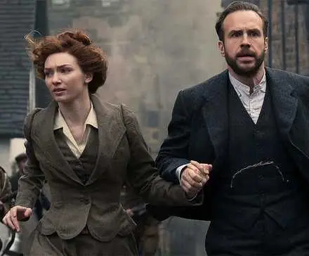 Rafe Spall and Eleanor Tomlinson holding hands while running in The War of the Worlds