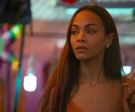 Zoe Saldana as Rita Mora Castro walking outside in Emilia Perez.