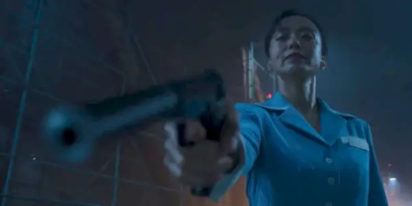 A woman aiming a gun down at someone off-camera in Kill Boksoon’ (2023)