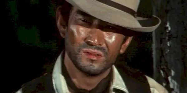 Ken Takakura staring down someone while wearing a cowboy hat in The Drifting Avenger
