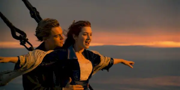 Jack holds Rose, who has her arms open wide, on the bow of the 