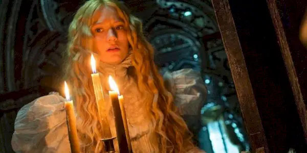 A woman holding a burning candlestick