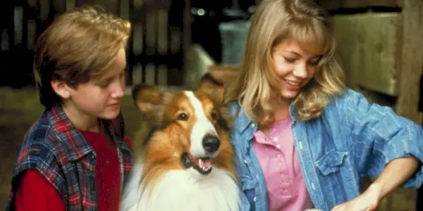 A young boy and a girl with a border collie in the 1994 movie Lassie