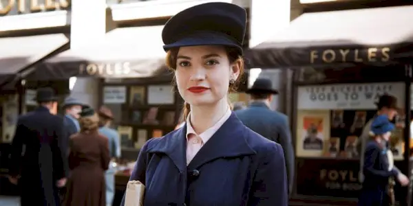 Juliet Ashton smirking while standing on the street in The Guernsey Literary and Potato Peel Society