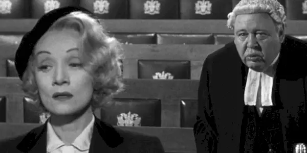 Marlene Dietrich as Christine Vole crying while a judge stands behind her in Witness for the Prosecution