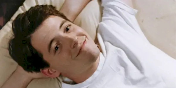 Ferris Bueller laying back and smiling in 