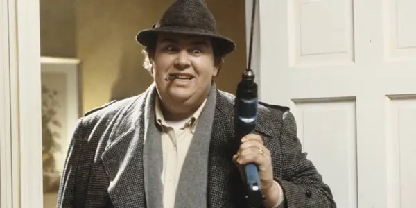 Uncle Buck smiling while holding a drill in Uncle Buck
