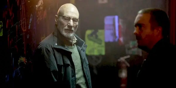 Darcy (Patrick Stewart) and Gabe (Macon Blair) hang around a seedy, graffiti-covered area in Green Room.