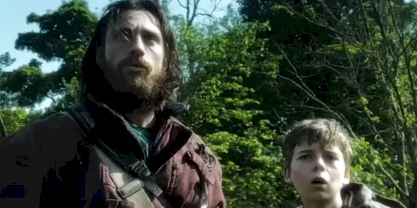 Aaron Taylor-Johnson Looking toward the camera alongside Alfie in the 28 Years Later trailer