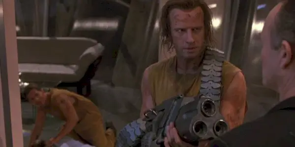 A man aiming a gun at someone in Fortress.