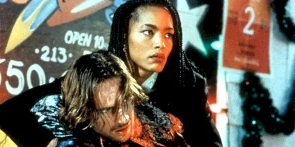 Mace carrying Lenny as they look in the same direction in Strange Days.