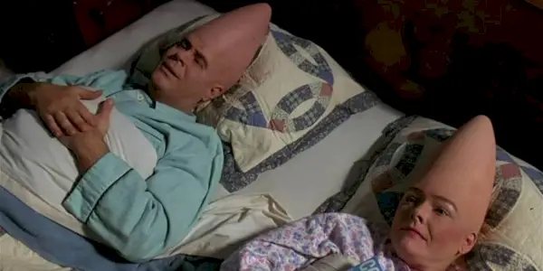 Dan Aykroyd and Jane Curtin as Beldar and Prymatt, in bed together in Coneheads.