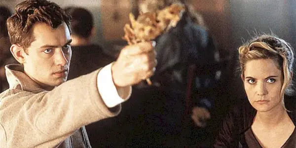 Ted aims his gun while Allegra looks on in eXistenZ