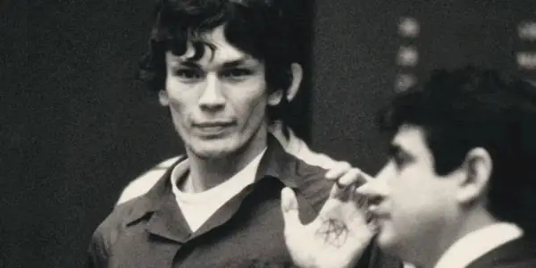 Richard Ramirez shows off his pentagram hand tattoo in the court room