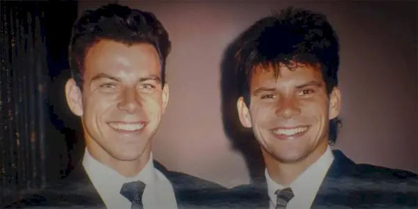 A picture of Lyle and Erick Menendez wearing suits and smiling in Netflix