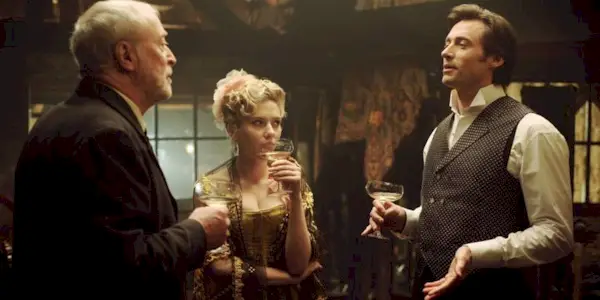 Cutter, Olivia, and Angier talking while drinking in The Prestige 