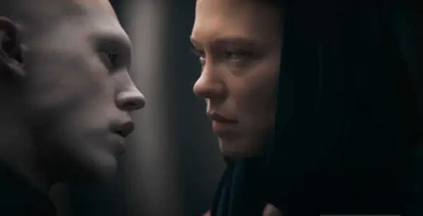 Austin Butler as the hairless Feyd-Rautha Harkonnen and Léa Seydoux as Lady Margot Fenring dressed in a blue headscarf and dress in Dune: Part Two.