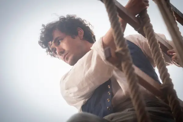 Jonah Hauer-King as Eric on a rope ladder