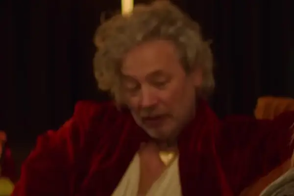 Dexter Fletcher plays Val Jones in Love at First Sight wearing a red robe