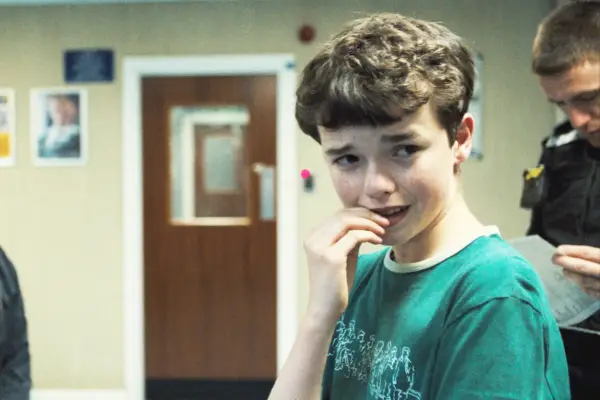 Owen Cooper as Jamie Miller, biting his nails, looks scared