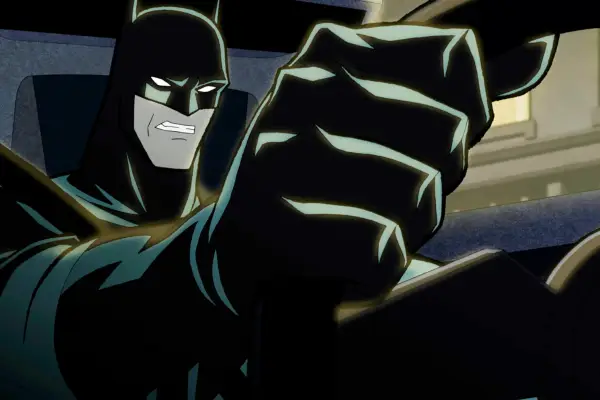 Batman drives the Batmobile in a scene from The Long Halloween