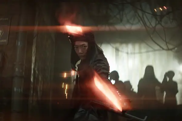 Nemesis wields two glowing weapons and adopts a stance that looks ready for combat