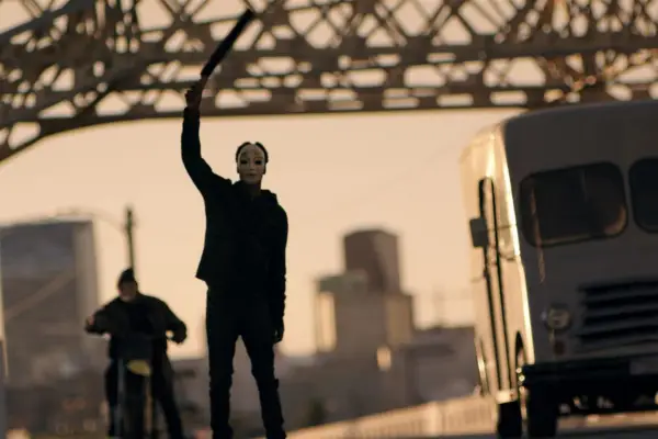 LaKeith Stanfield in The Purge: Anarchy holding a weapon aloft