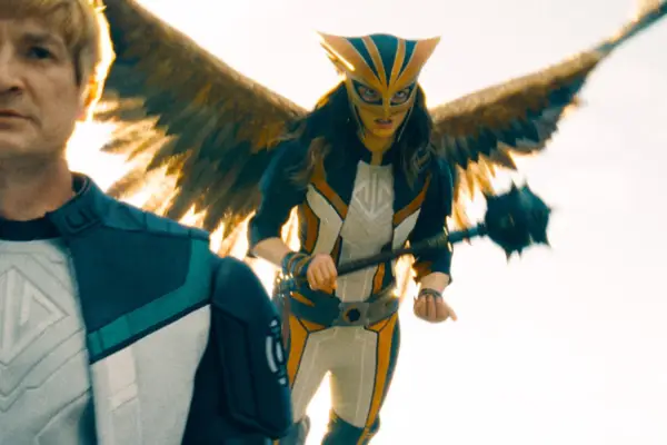 Isabela Merced plays Hawkgirl in Superman, wearing her full superhero costume including giant wings and a helmet, while wielding a mace