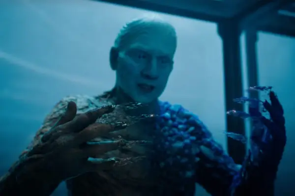 Anthony Carrigan plays Metamorpho in Superman, seen here bringing his hands together as they transform into crystallised form