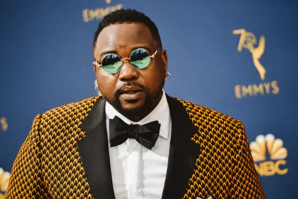 Brian Tyree Henry wearing a yellow and black suit