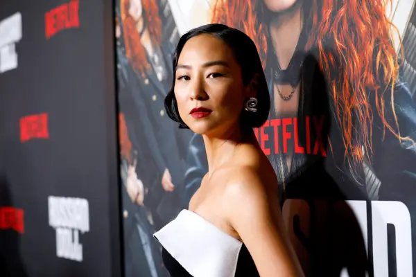 Greta Lee in a white and black dress