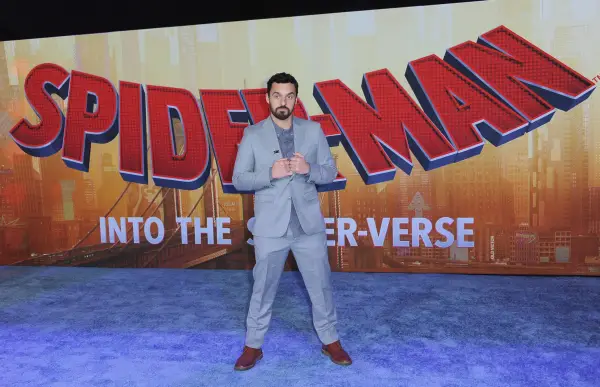 Jake Johnson wearing a blue suit