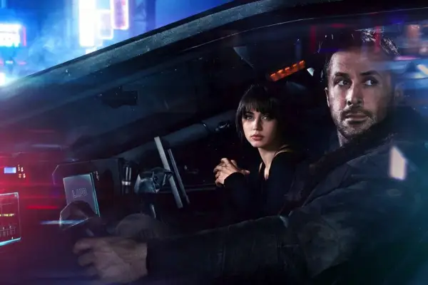 Ana de Armas and Ryan Gosling in Blade Runner 2049 sat in a car looking out of the window
