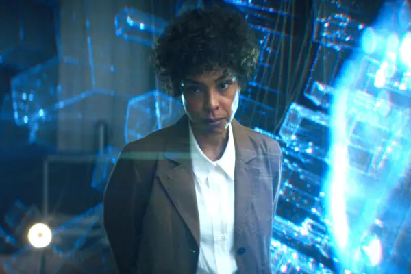 Gal Gadot as Rachel Stone in Heart Of Stone, sitting in a chair, covered in scratches and bruises and holding her side