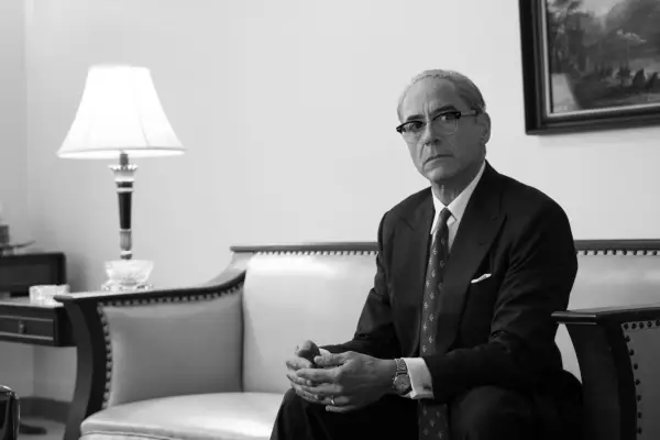 Robert Downey Jr is Lewis Strauss in OPPENHEIMER, wearing a suit with slicked back hair