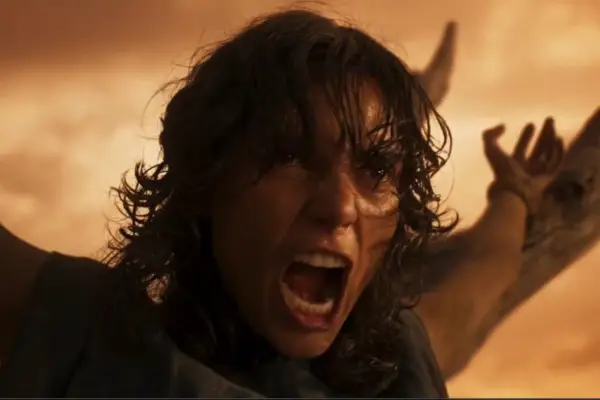 Charlee Fraser plays Mary Jo Bassa in Furiosa: A Mad Max Saga with her arms outstretched screaming