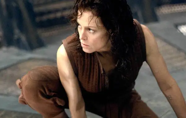 Sigourney Weaver as Ripley 8 crouching on the floor in Alien Resurrection.